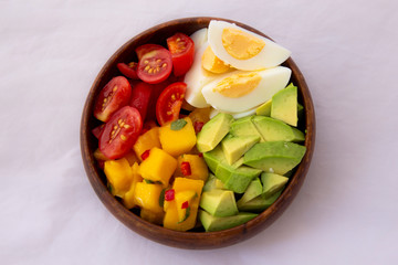 Salad with mango, avocado, egg, romeo tomatoes