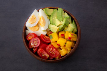 Salad with mango, avocado, egg, romeo tomatoes