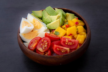 Salad with mango, avocado, egg, romeo tomatoes