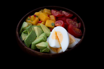 Salad with mango, avocado, egg, romeo tomatoes