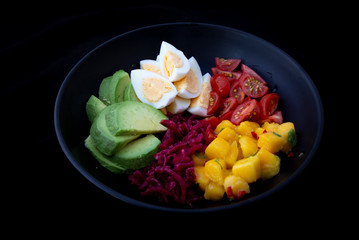 Salad with mango, avocado, egg, romeo tomatoes