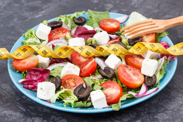 Centimeter and greek salad with feta cheese and vegetables. Slimming, healthy lifestyles and...