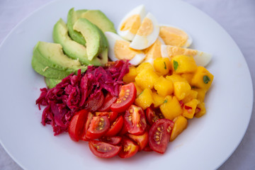 Salad with mango, avocado, egg, romeo tomatoes