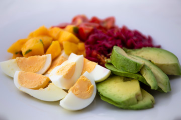 Salad with mango, avocado, egg, romeo tomatoes