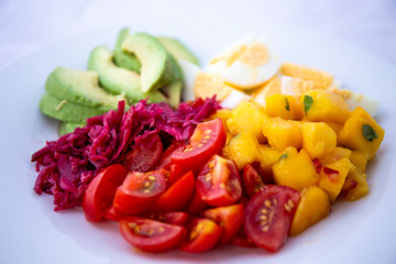 Salad with mango, avocado, egg, romeo tomatoes
