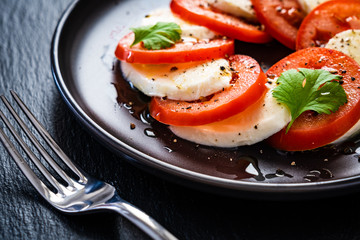 Caprese salad on black stone