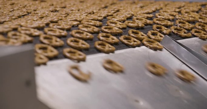 Snacks production Closeup conveyor, baked pretzel snacks