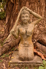 Statue of Lao Woman Kneeling, Washing Hair, Warm Hues, Portrait