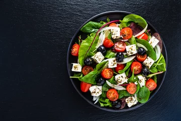 Fototapeten Fresh greek salad - feta cheese, tomato, lettuce, black olives and onion © Jacek Chabraszewski