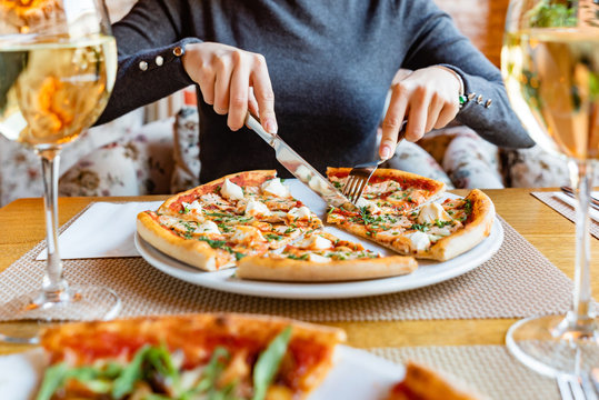 Woman Eating Pizza In The Cafe