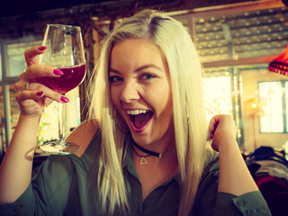 Girl with alcohol glass in pub club