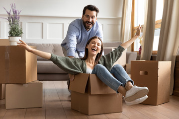 Excited young couple have fun on moving day