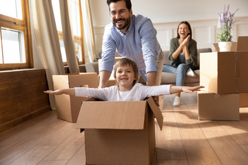 Excited father have fun with little son on moving day