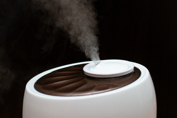 Humidifier in the house on black background