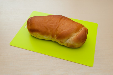 Delicious homemade Brazilian bread. Isolated on beige wooden background. Horizontal shot.