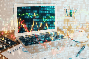 Forex market graph hologram and personal computer on background. Multi exposure. Concept of...