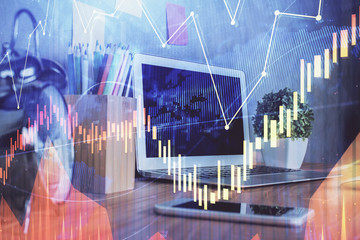 Financial graph colorful drawing and table with computer on background. Double exposure. Concept of international markets.