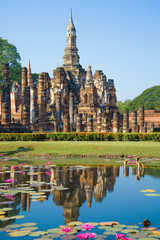 A fragment of the ruins of the ancient Buddhist temple of Wat Mahathat by sunny day. Suchotai. Thailand