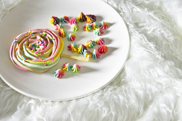 A dessert made from sugar is a rainbow circle. Brownie Candy in white plate