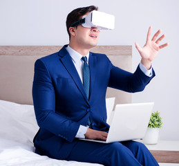 Businessman wearing a virtual reality headset in the bedroom
