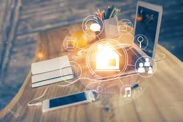 Desktop computer background in office and big town buildings hologram drawing. Double exposure. Smart city concept.