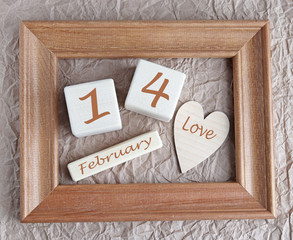 Wooden cubes hearts in a frame February 14
