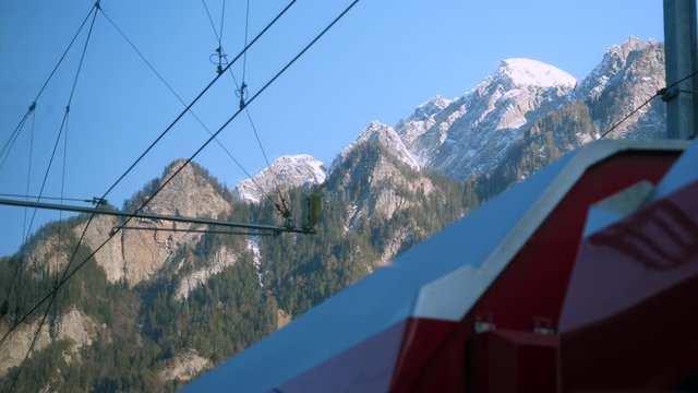 Partial view of Glacier Express train and snow capped mountains in Switzerland