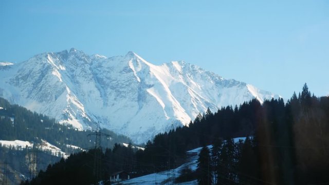 Glacier Express train view of snow capped mountains and landscape in Switzerland