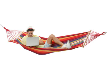 Man with laptop in hammock on white background