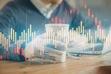 Forex graph with businessman working on computer in office on background. Concept of hardworking. Closeup. Multi exposure.