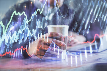 Forex graph with businessman working on computer in office on background. Concept of hardworking. Closeup. Multi exposure.