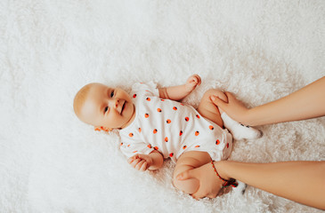 Female doing massage and gymnastic baby. massage to the baby. masseur's hands close-up, make a...
