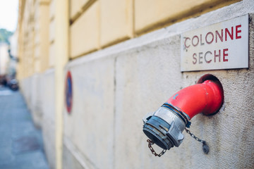 Fire hydrant on the wall. Old Town, Nice, France