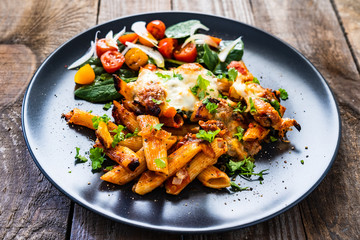 Pasta casserole with barbecue chicken breast, cheese and vegetables