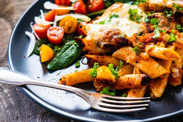 Pasta casserole with barbecue chicken breast, cheese and vegetables