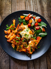 Pasta casserole with barbecue chicken breast, cheese and vegetables