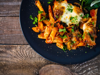Pasta casserole with barbecue chicken breast, cheese and vegetables