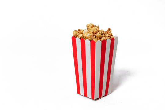 Movie Popcorn in striped bucket isolated on white background
