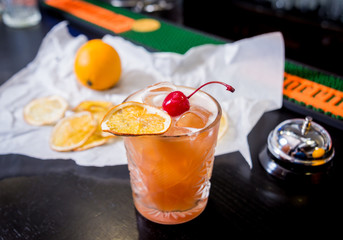 Non alcoholic cocktail with lemon and oranges at wooden bar counter. Restaurant.