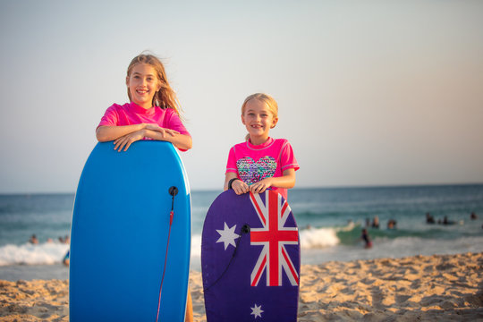 Two Aussie girls on the beach with their body boards