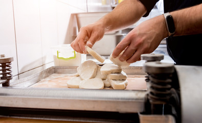 Chef preparing dough for pastry, dumplings, italian pasta or japanese wontons. Cooking. Restaurant kitchen.