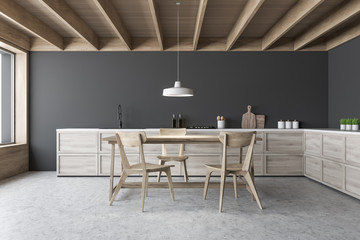 Gray kitchen interior, countertops and wood table