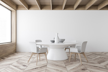 White dining room interior with round table