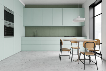 Green kitchen interior with round table