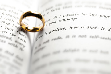 Golden wedding ring on bible book