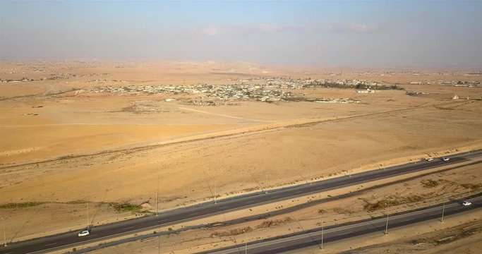 Aerial footage over Desert road with Bedouin settlements, Israel Rout 25, Dimona Beer sheba road, Bedouin settlements, Drone shot, Negev Israel