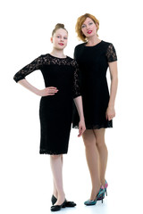 Mom and little daughter studio portrait on a white background.