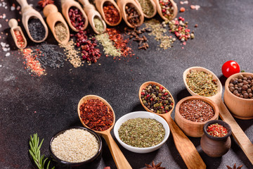 Spices and herbs over black stone background. Top view with free space for menu or recipes