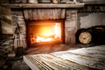 Desk of free space and fireplace in home interior 