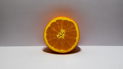 The orange in front of the camera.